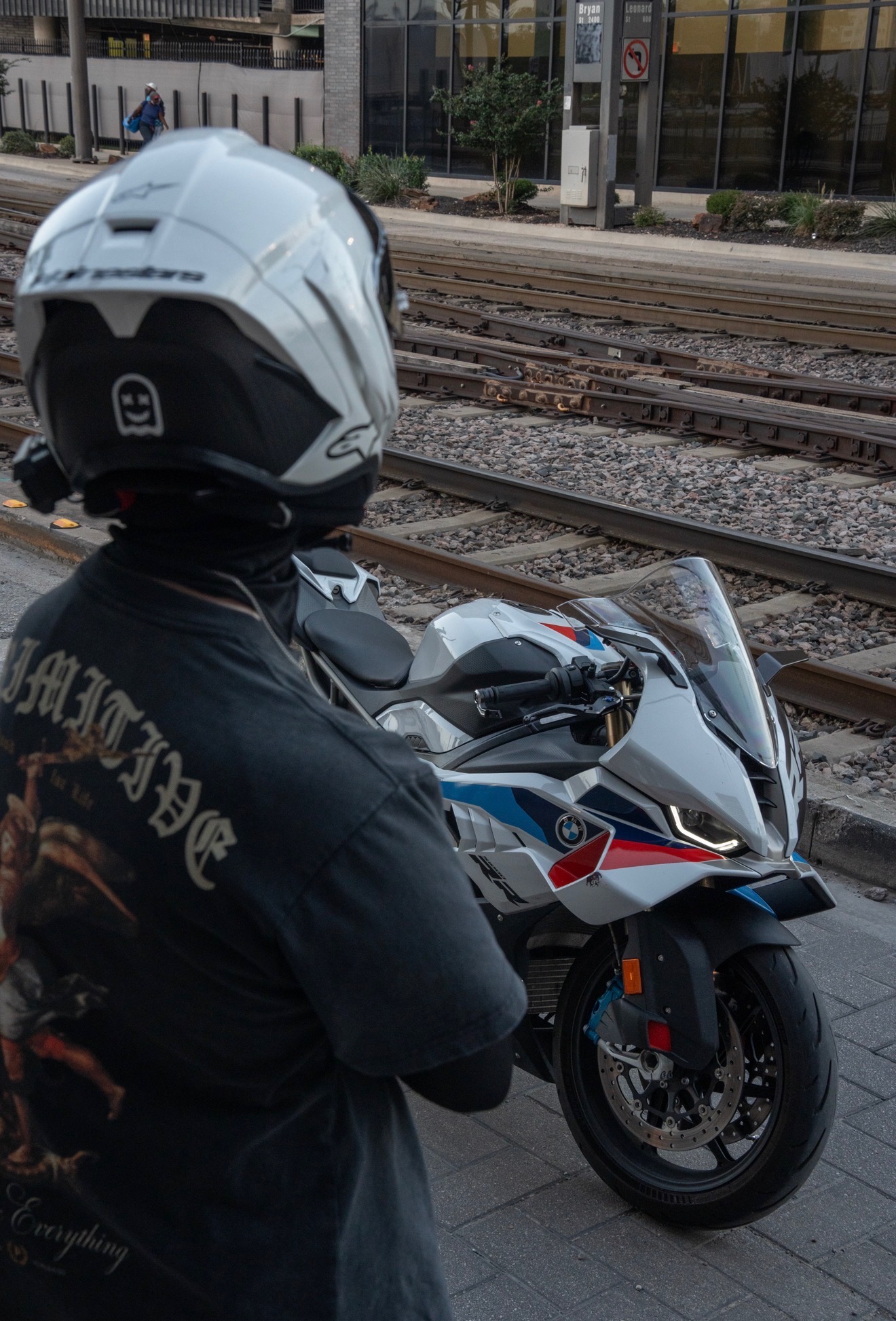 Blaze viewed from behind on his BMW S1000RR near light rail tracks.