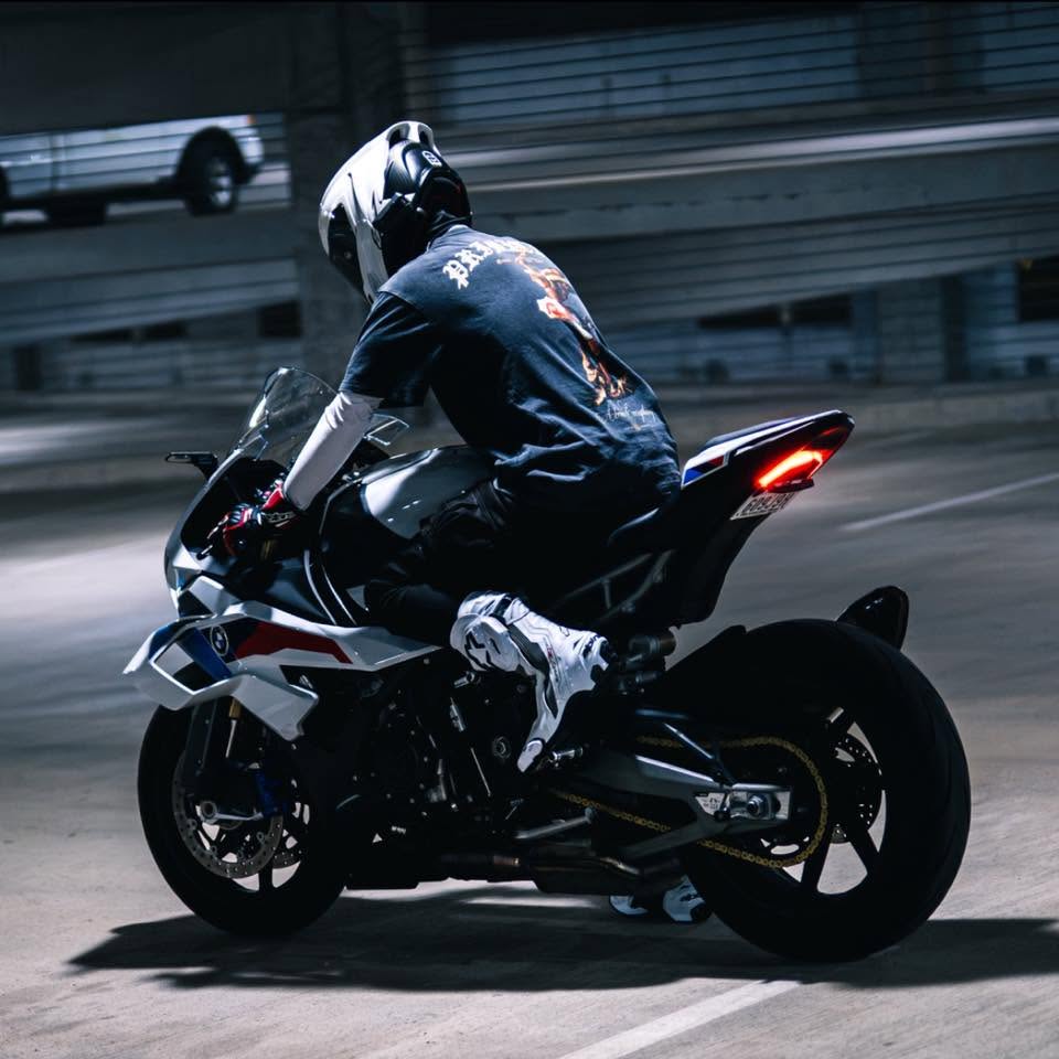 Blaze riding his BMW S1000RR through a parking garage at night with the rear wheel breaking loose.